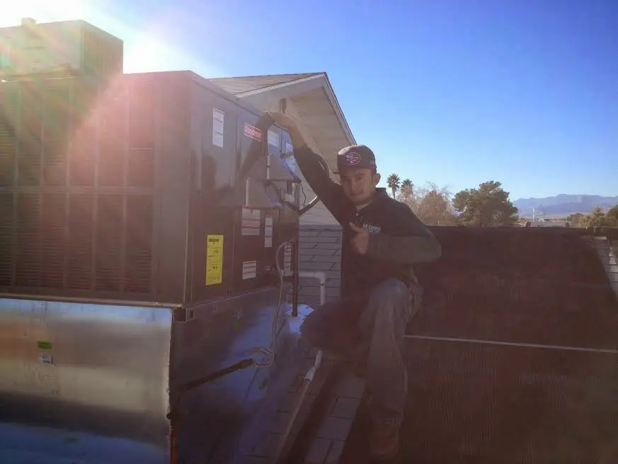 HVAC technician performing HVAC Inspection on a rooftop unit in Detroit Lakes